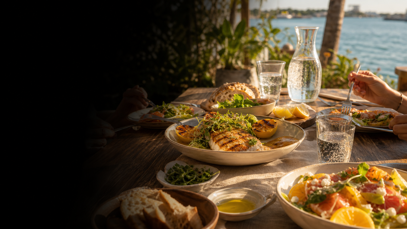 Coastal restaurant table overlooking the water at sunset